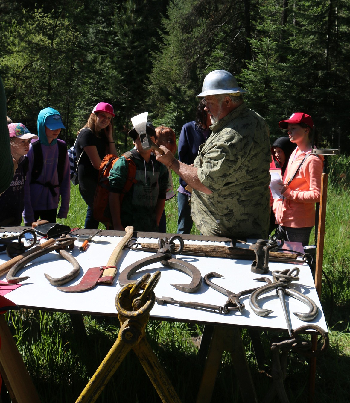 &#151;Photo by LYNNE HALEY
Elton Turcotte, foreground, teaches students about the tools of the trade at the 34th annual Idaho State Forestry Contest. The contest, which was held at the Delay Tree Farm attracted students from throughout the state.