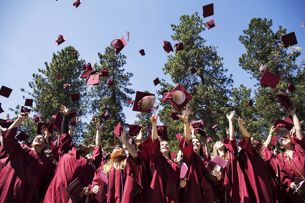 LOREN BENOIT/Hagadone News Network
North Idaho College graduates celebrate by tossing their caps in the air after receiving their degrees and certificates on Friday.