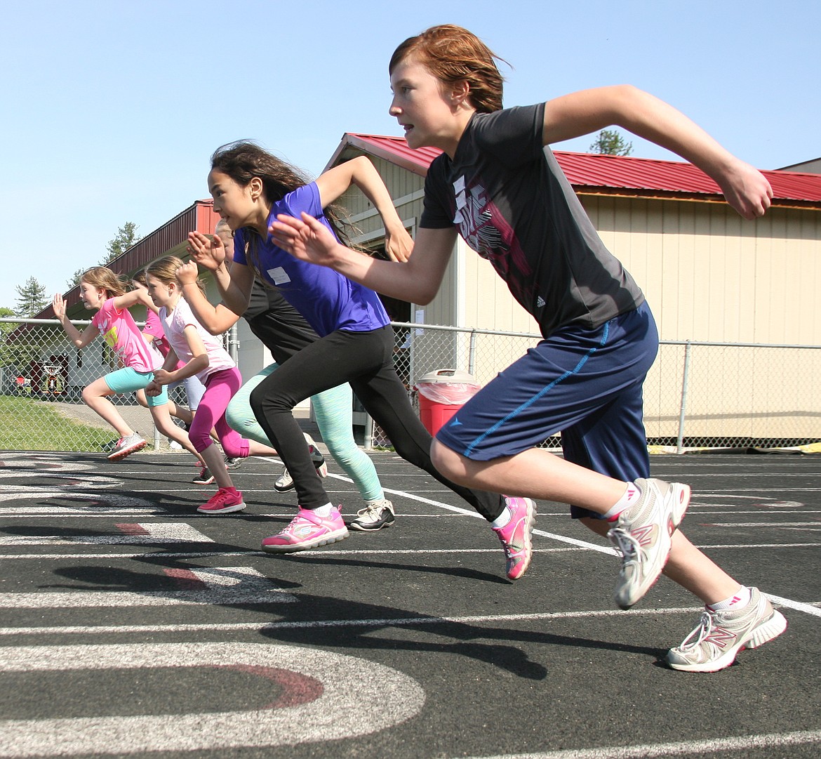 &#151;Photo by ERIC PLUMMER
Participants of the girls 11-12 year-old 100 meter dash take off out of the starting blocks during a recent youth track meet at SHS.