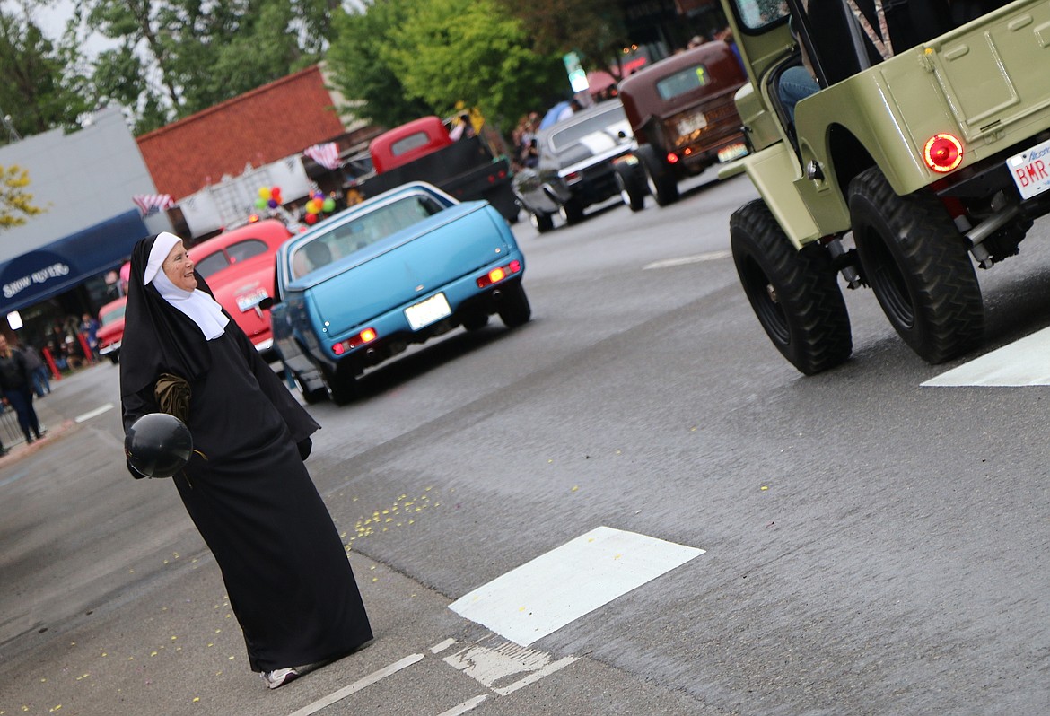 &#151;Photo by CAROLINE LOBSINGER
A parade flagger has fun during Friday&#146;s Lost in the &#145;50s parade on First Avenue.