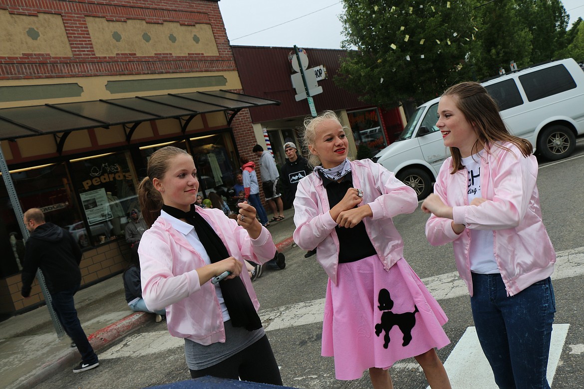 &#151;Photo by CAROLINE LOBSINGER
Breann Klopman, Quinn Hooper and Sydnie Knepper have fun as they watch the Lost in the &#145;50s parade Friday on First Avenue.