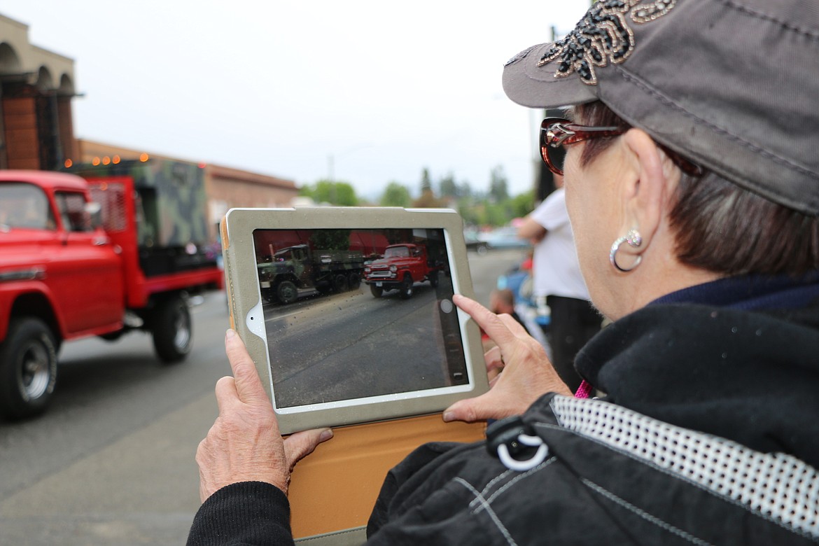 &#151;Photo by CAROLINE LOBSINGER
Dian Chartier takes a photo with her tablet as she watches the Lost in the &#145;50s parade Friday on First Avenue.