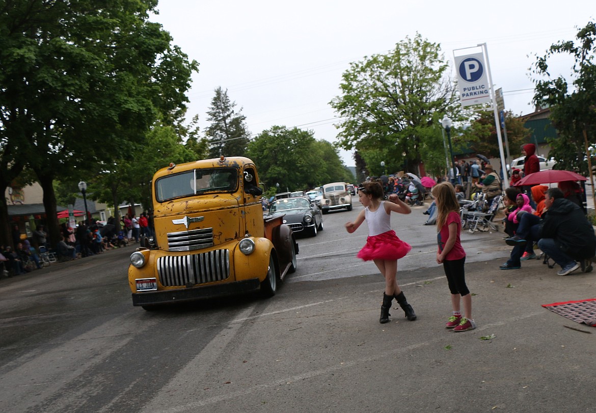 &#151;Photo by CAROLINE LOBSINGERClassic cars make their way down Church Street during Friday&#146;s Lost in the &#145;50s parade as a fan twirls in delight.