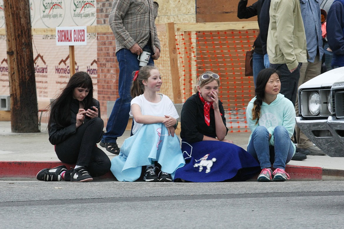 A quartet of &#145;50s fans watch as the cars drive past them at the corner of Second and Church during Friday&#146;s Lost in the &#145;50s parade.