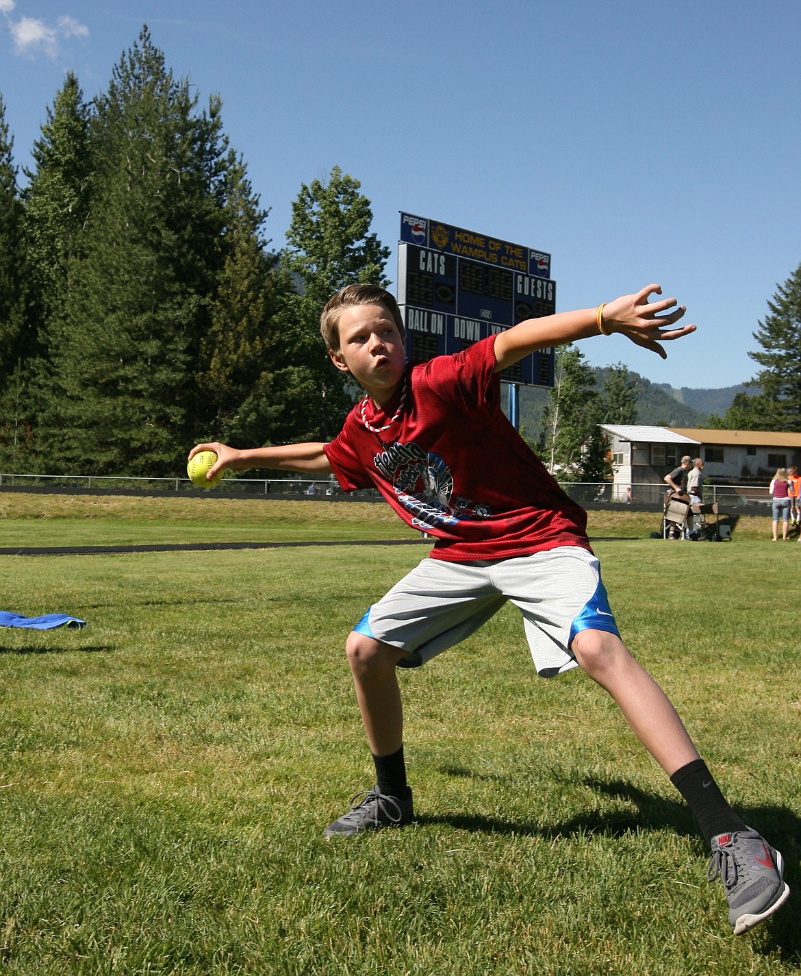 ABOVE: Cody Newhart, a 5th grader from Sagle Elementary, uncorks a bomb in the softball throw. Farmin-Stidwell, Hope, Kootenai, Northside, Sagle, Southside and Washington Elementary Schools each hold their own qualifying, with the top marks earning the right to compete in the district meet, run adeptly by K.C. MacDonald and the Clark Fork students and teachers. Washington Elementary edged Sagle to win the overall team title.

RIGHT: Olivia Yetter, a 3rd grader from Hope Elementary, takes part in the long jump. A couple things always stick out about the meet: One, the weather is always nearly perfect for this event; and two, the energy and enthusiasm of the kids is palpable, as they enjoy both the thrill of competition and being out of the classroom on a June morning. See the Bee next week for the results. 
&#151;Photos by ERIC PLUMMER