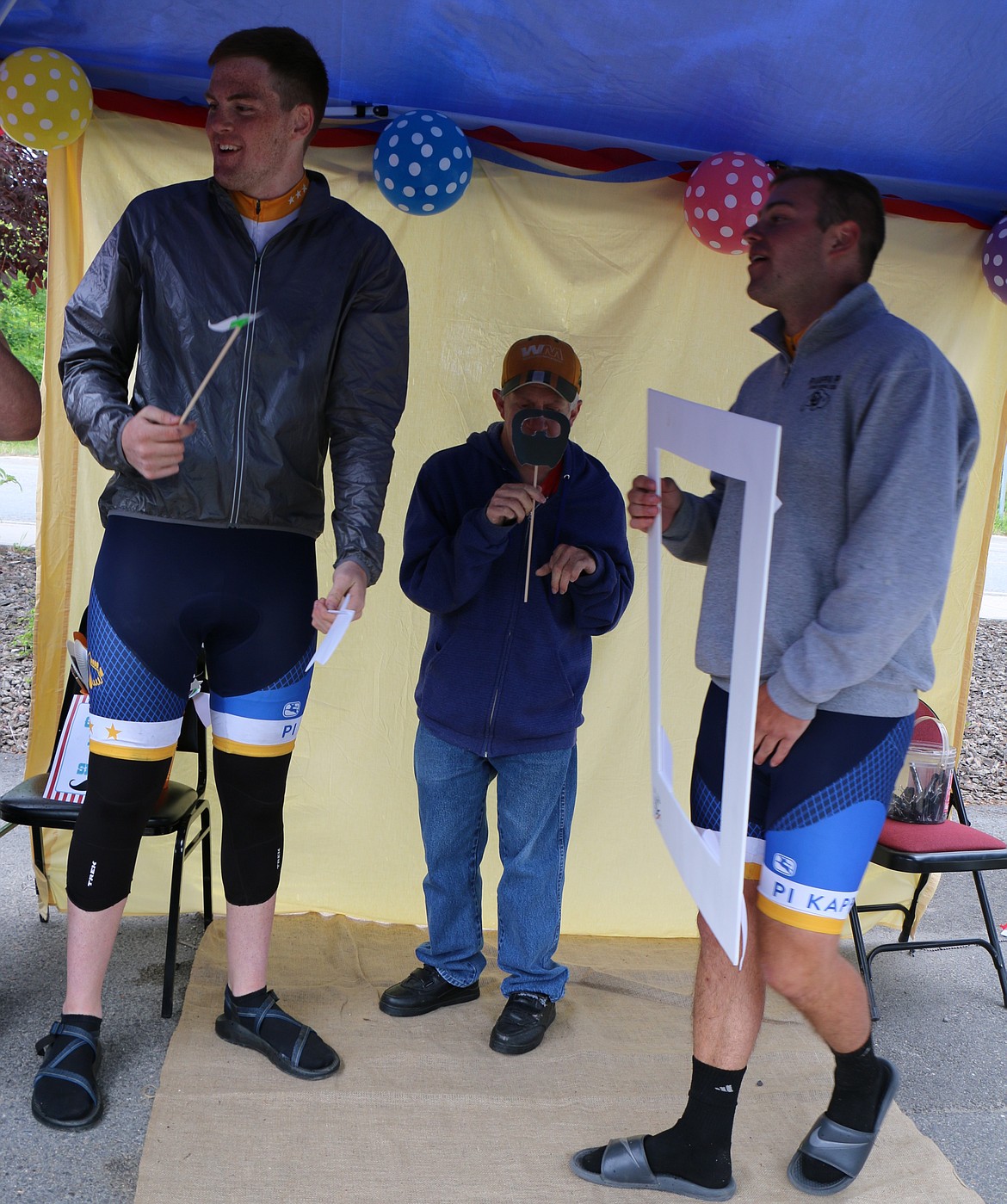 -- Photo by LYNNE HALEY

Smiles were the order of the day as cyclists on a cross-country trek to raise awareness about people with special needs take a break in the photo booth with a PSNI participant, center.