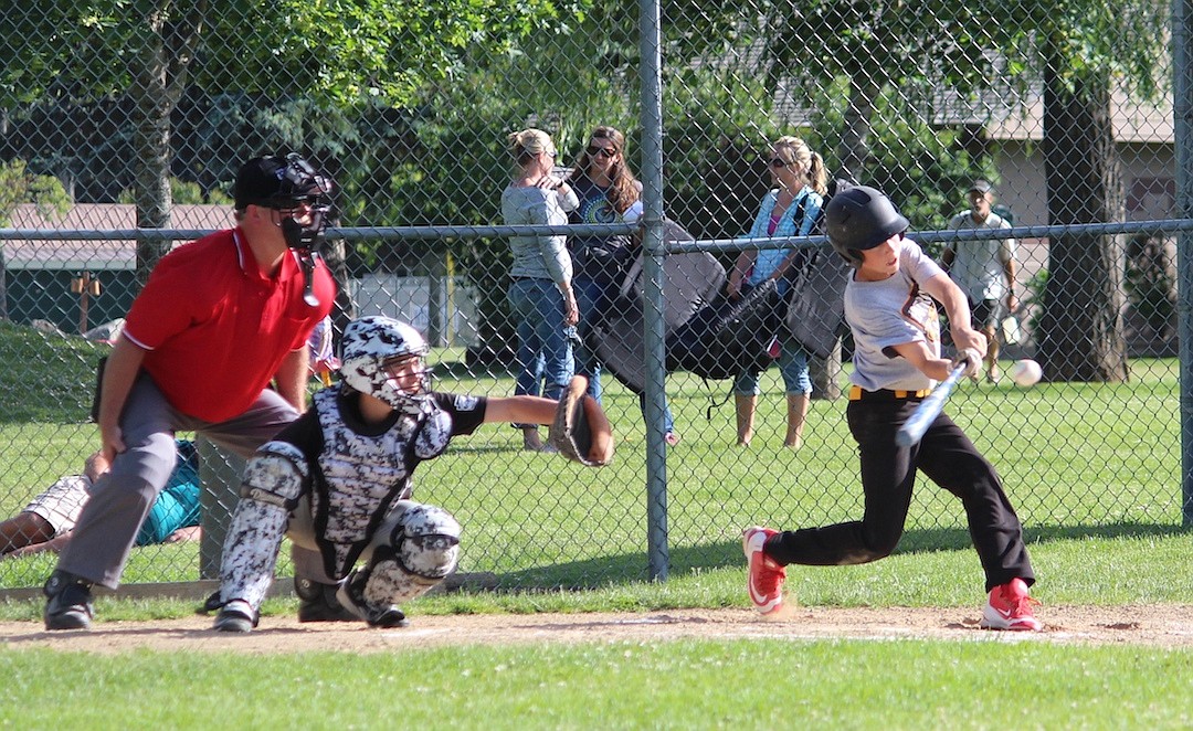 Hunter Jacobson, left, squares up a pitch in front of catcher Gerrit Cox and local umpire Jude Ackerman in the championship game. Cox did not have a run scored on him all season due to a stolen base when catching, setting a high standard for himself behind the plate. Ackerman was head umpire and coordinated all of the crews. &#147;He has been a tremendous asset to Sandpoint Little League,&#148; said league president Tony Butler. &#147;He does a great job not only officiating games, but mentoring new umpires and developing a pool of umps to work with.&#148; All Star practices have begun with Sandpoint teams participating at the district tournaments, which begin on June 24.
&#151;Courtesy photo