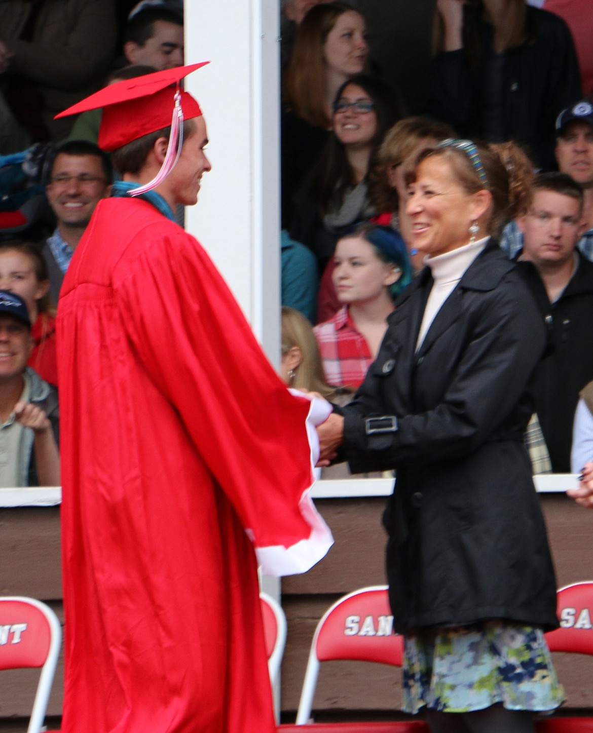 -- Photo by LYNNE HALEY

Dr. Becky Meyer, assistant superintendent for Lake Pend Oreille School District, right, congratulates a graduate.