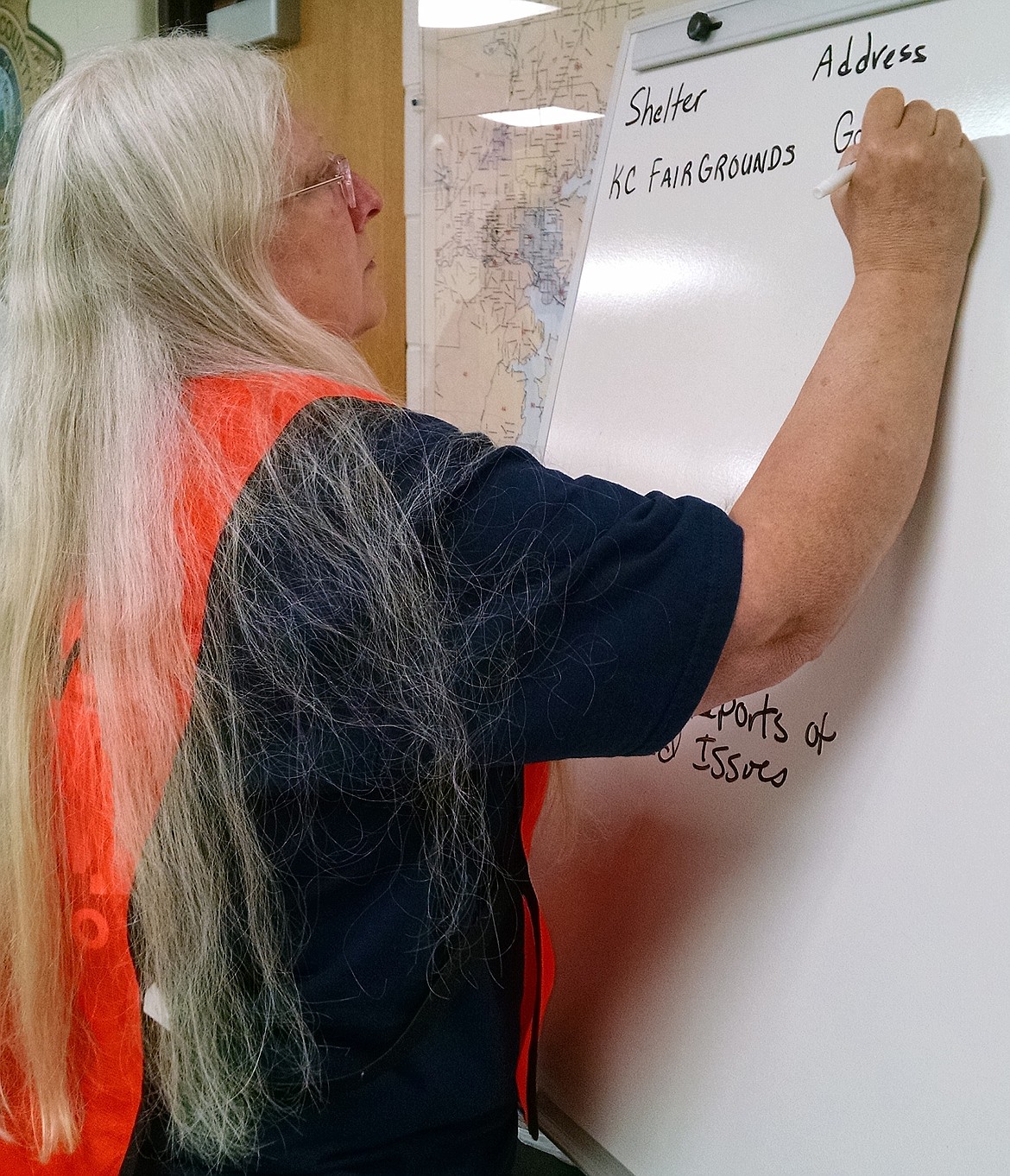 BRIAN WALKER/Press
Vanessa Hanson, a public information officer, marks where emergency shelters will be set up during Thursday's emergency operations center drill at the Kootenai County Sheriff's Office.