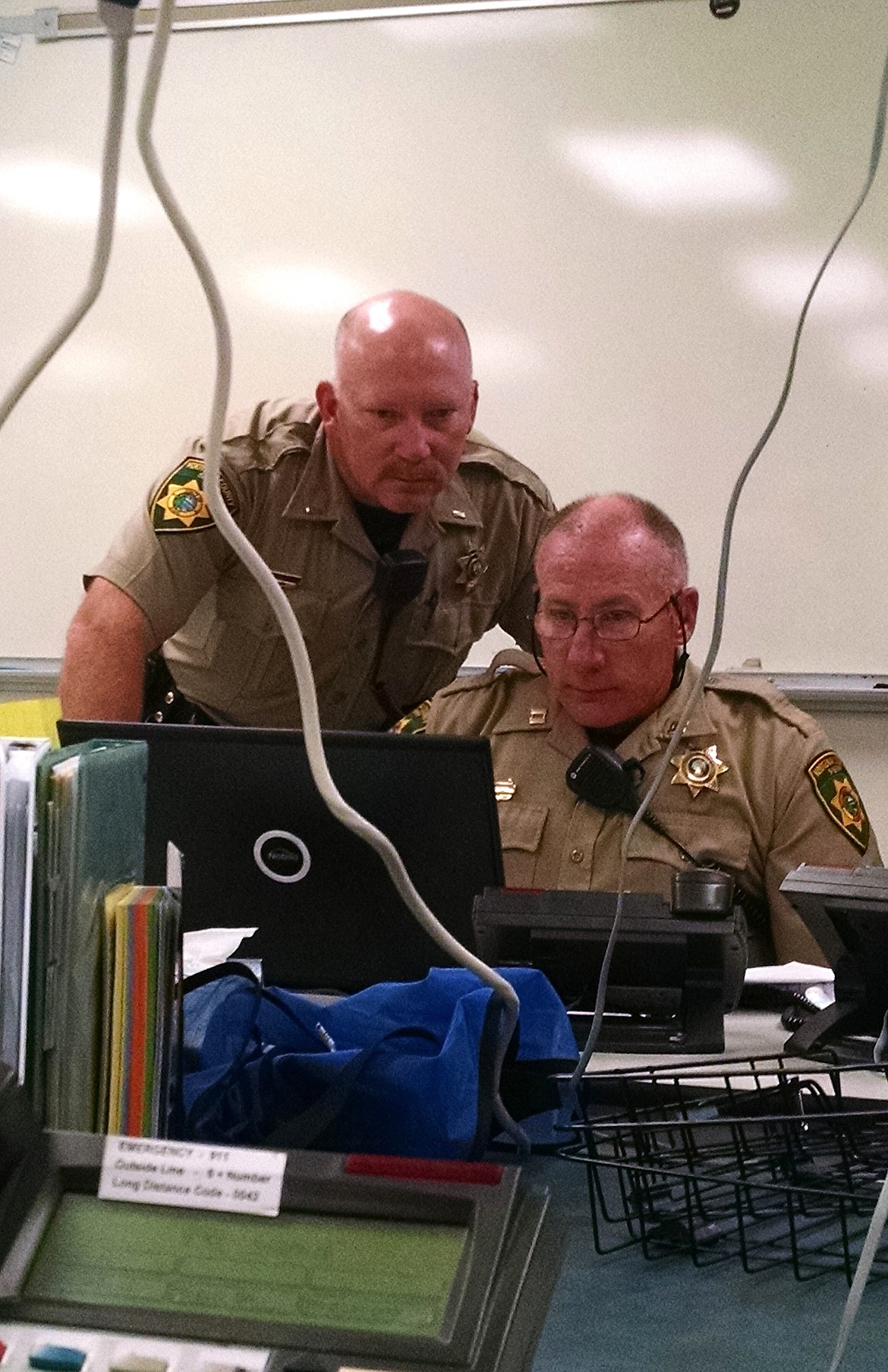 BRIAN WALKER/Press
Stu Miller, left, and Andy Boyle, both of the Kootenai County Sheriff's Office, work in the emergency operations center at the KCSO on Thursday.