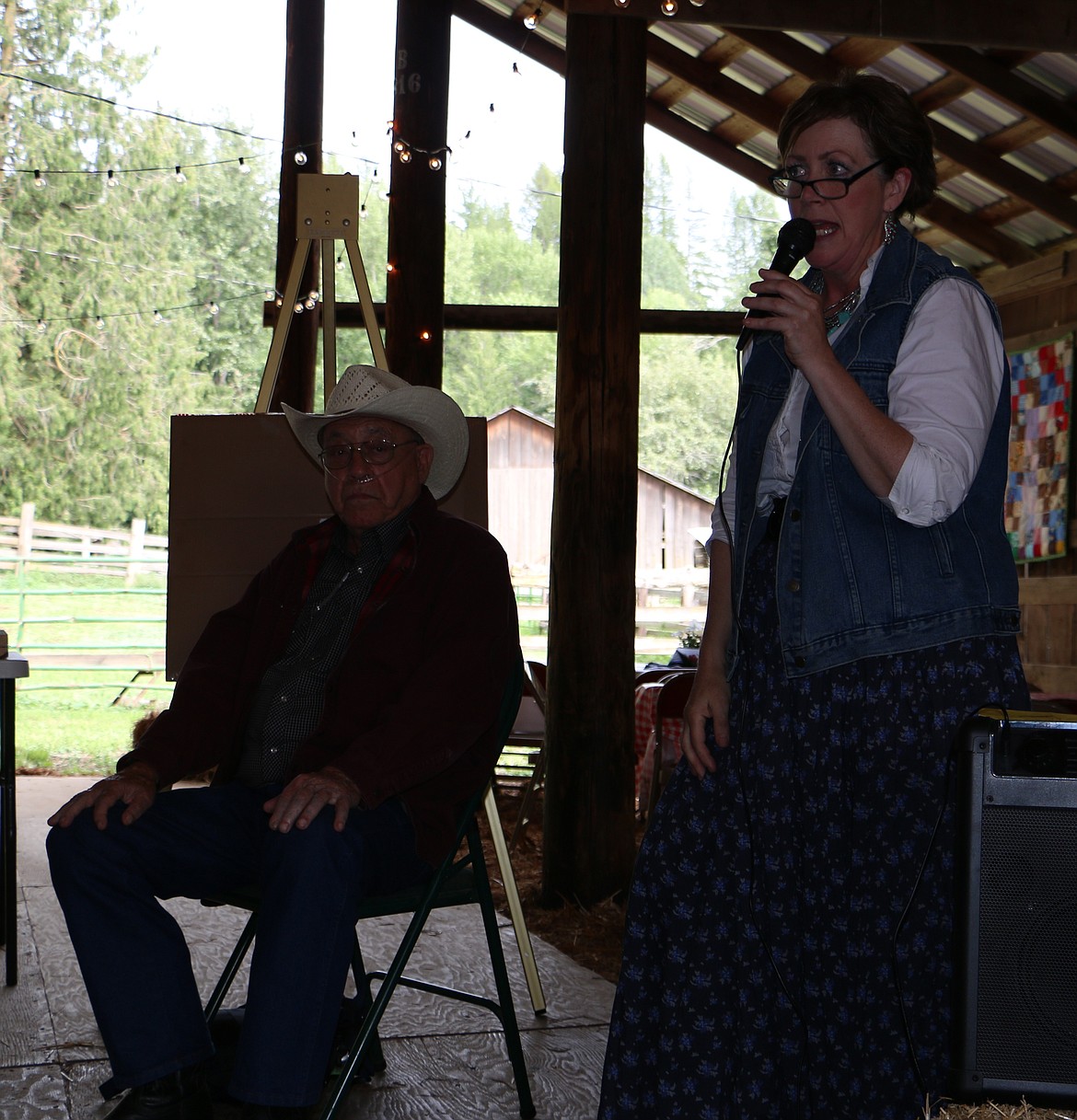 -- Photo by LYNNE HALEY

Don Albertson, seated, and his daughter Tracie Roos regale their assembled friends with tales of A-T Ranch's history.