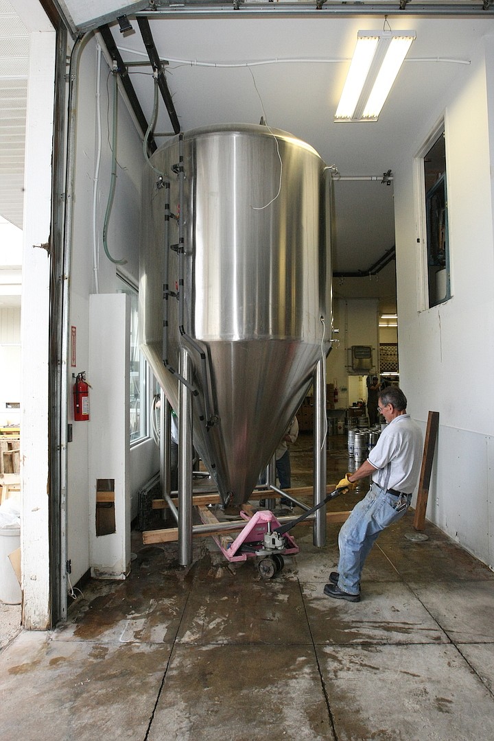 &#151;Photo by JIM McKIERNAN
John Vitale moves a fermenter in the old facility out of its location with a pallet jack so that it can be tipped over into a cradle for transportation.