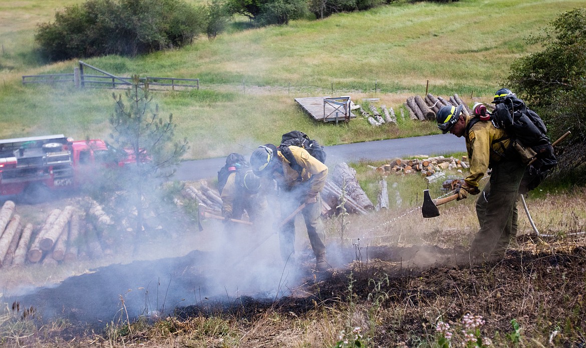 KATIE HARTWIG/PressForestry workers work together to contain demonstration fire, Thursday.