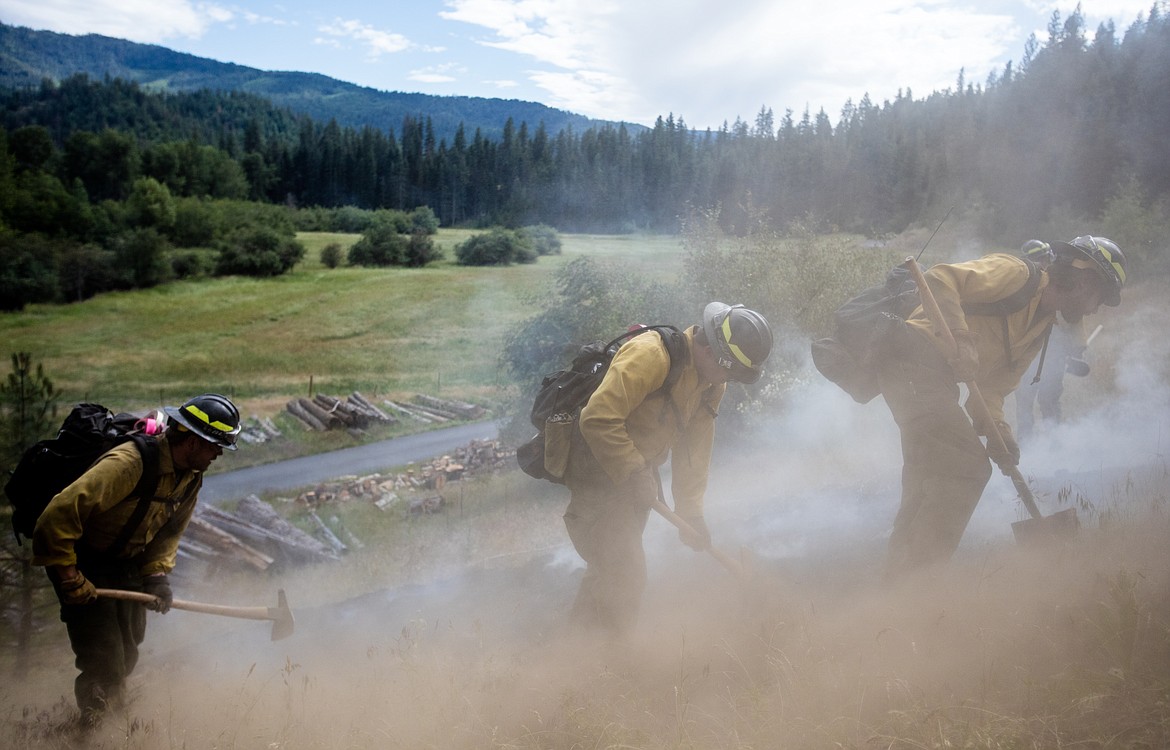 KATIE HARTWIG/PressForestry workers work together to contain demonstration fire, Thursday.