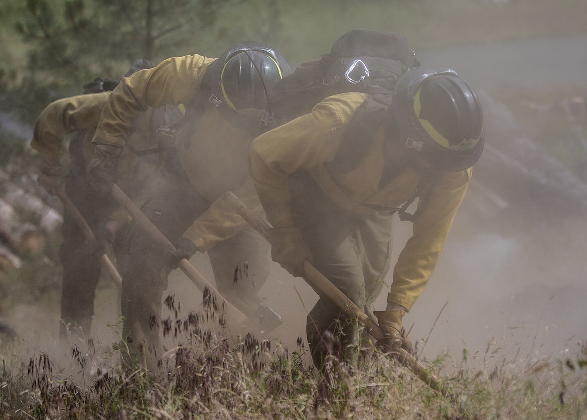 KATIE HARTWIG/PressForestry workers work together to contain demonstration fire, Thursday.