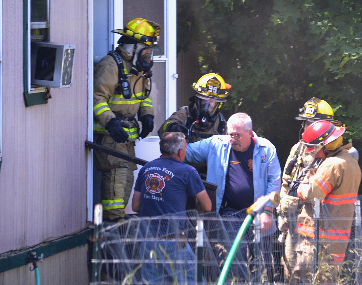 Photo by: SARAH JENKINS
BFFD responding to fire on Monday afternoon. Pictured are BFFD rescuing the occupant&#146;s dogs. Valiant efforts were made by BFFD and BVA to save all trapped dogs; unfortuantely two did not survive.