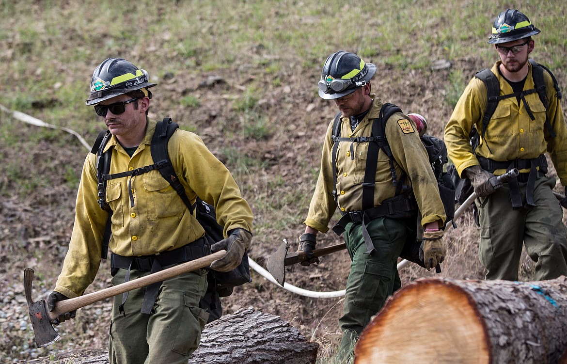 KATIE HARTWIG/Pressgo back to engine after extinguishing demonstration fire Thursday.