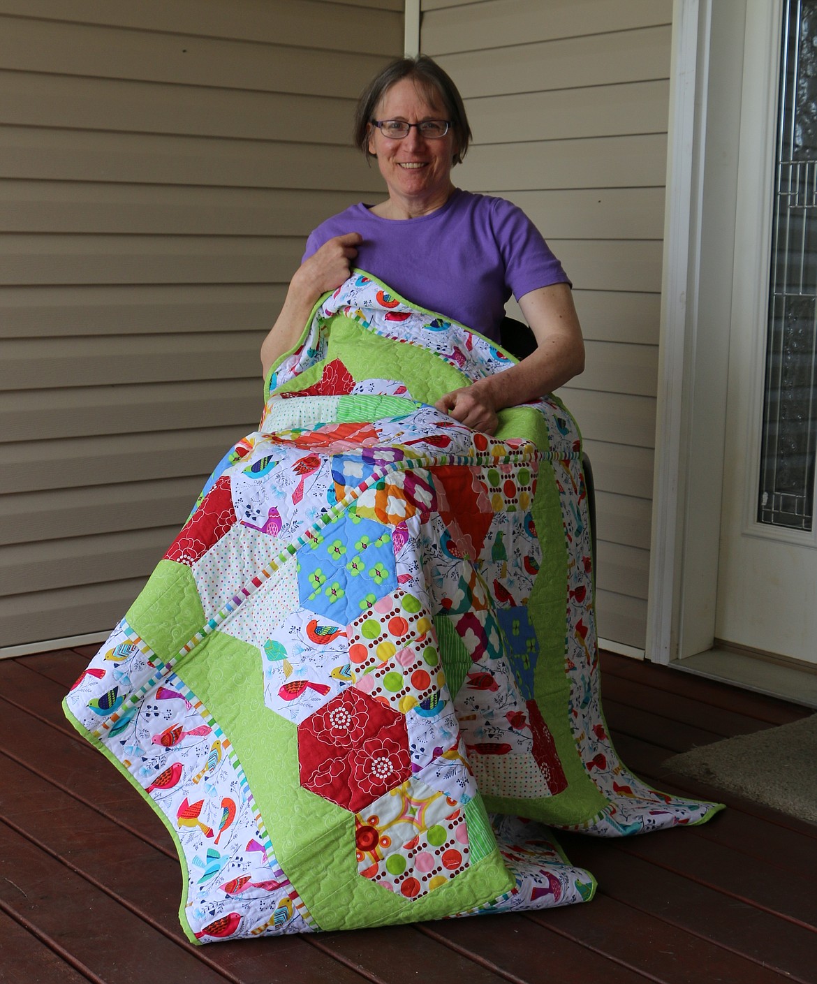 &#151;Photo by LYNNE HALEY
Master quilter Carol Beber shows off a quilt that reflects her love of color, light and jigsaw puzzles. Beber is the featured quilter for this year&#146;s Panhandle Piecemakers Quilt Guild&#146;s Festival of Quilts.