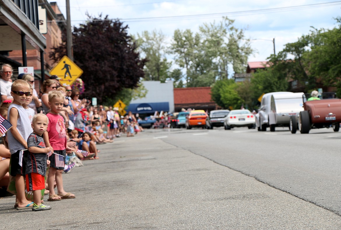 &#151;Photo by CAROLINE LOBSINGER
A trio of young boys appear captivated by classic cars driving by Sandpoint Car Injectors members during Monday's Grand Parade. The entry was just one of about 100 which took part in the Sandpoint Lions Club event.