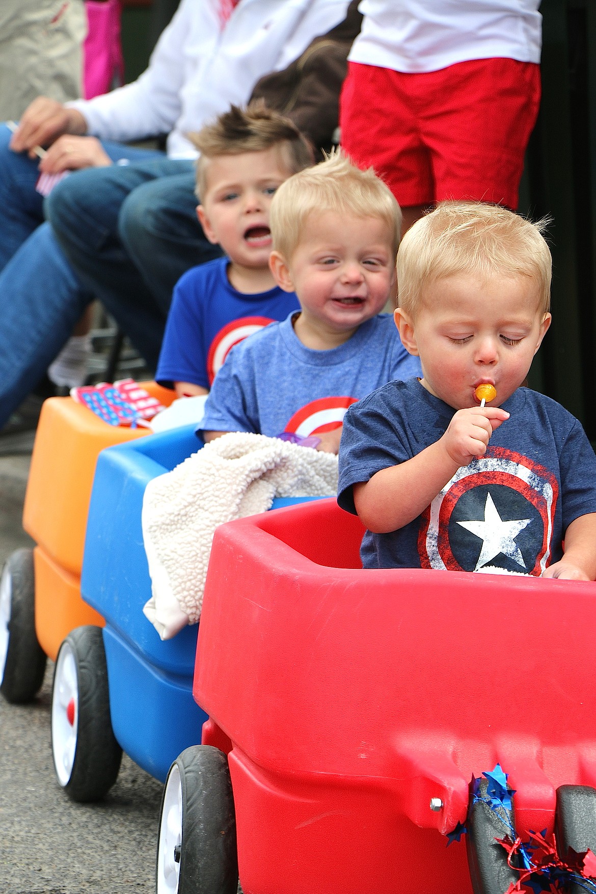 &#151;Photo by CAROLINE LOBSINGER
A trio of parade watchers have varying reactions to the Fourth of July fun going on around them at Monday&#146;s Grand Parade.