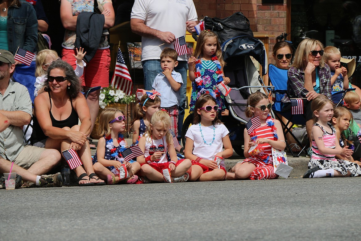 &#151;Photo by CAROLINE LOBSINGER
A group of youngsters watch the floats go by during Monday's Fourth of July Grand Parade.