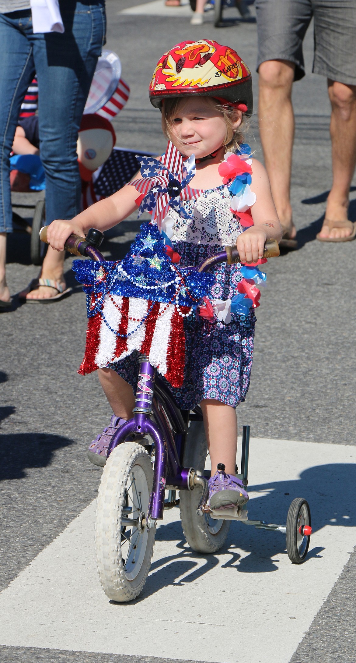 &#151;Photo by CAROLINE LOBSINGER
A young bicyclist rides in the Fourth of July Kids Parade on Monday.