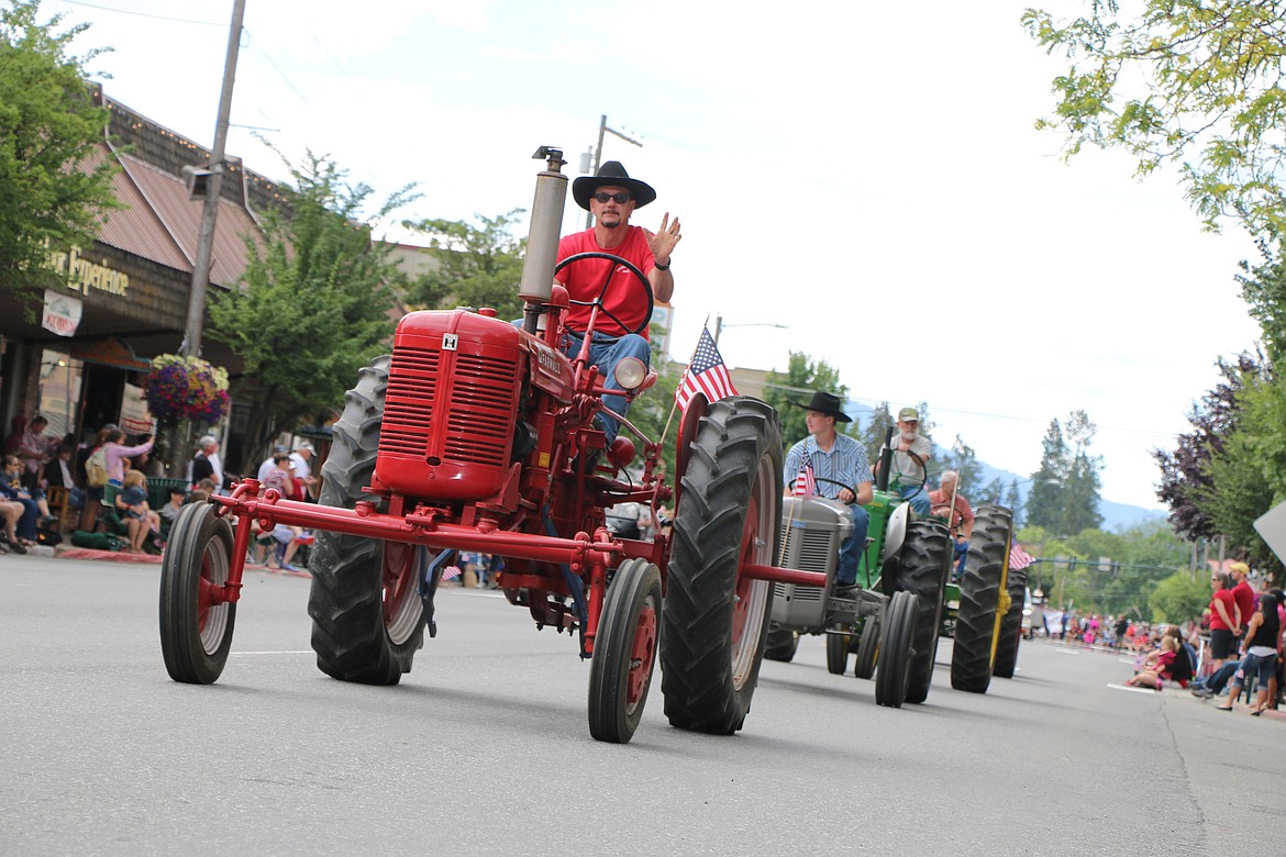 &#151;Photo by CAROLINE LOBSINGER
Panhandle Antique Tractor and Engine Club members make their way down First Avenue during Monday's Fourth of July parade.