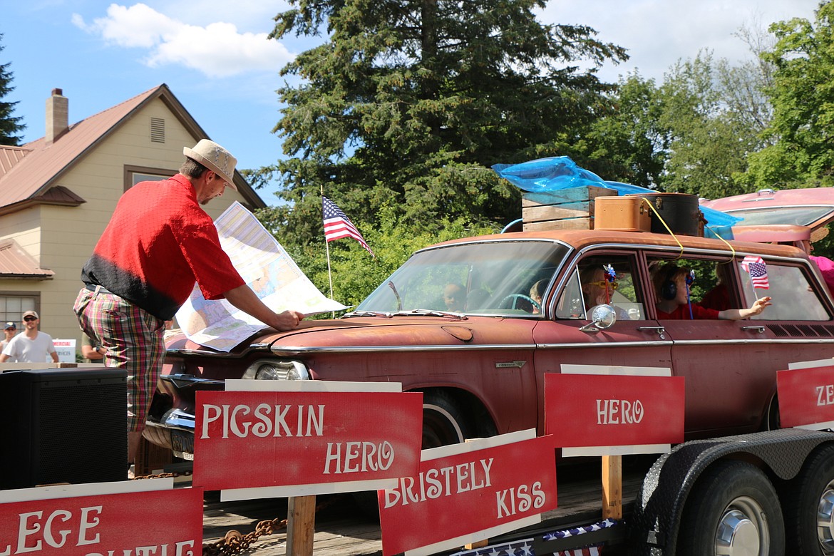 &#151;Photo by CAROLINE LOBSINGER
A parade participant pretends to be trying to find his way to Disneyland during Monday's Grand Parade. The float was one of about 100 entries in the Sandpoint Lions' Fourth of July event.