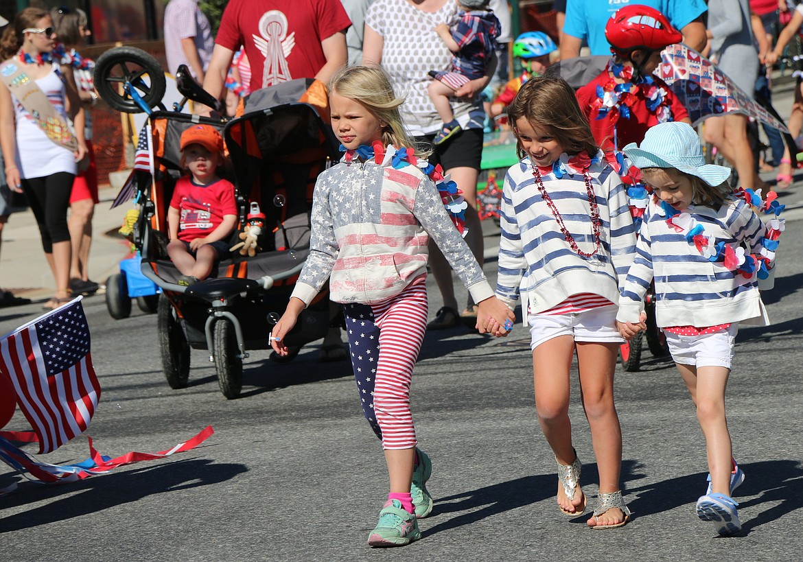 &#151;Photo by CAROLINE LOBSINGER
A trio wear flag-inspired clothing as they walk in the Fourth of July Kids Parade on Monday in downtown Sandpoint.