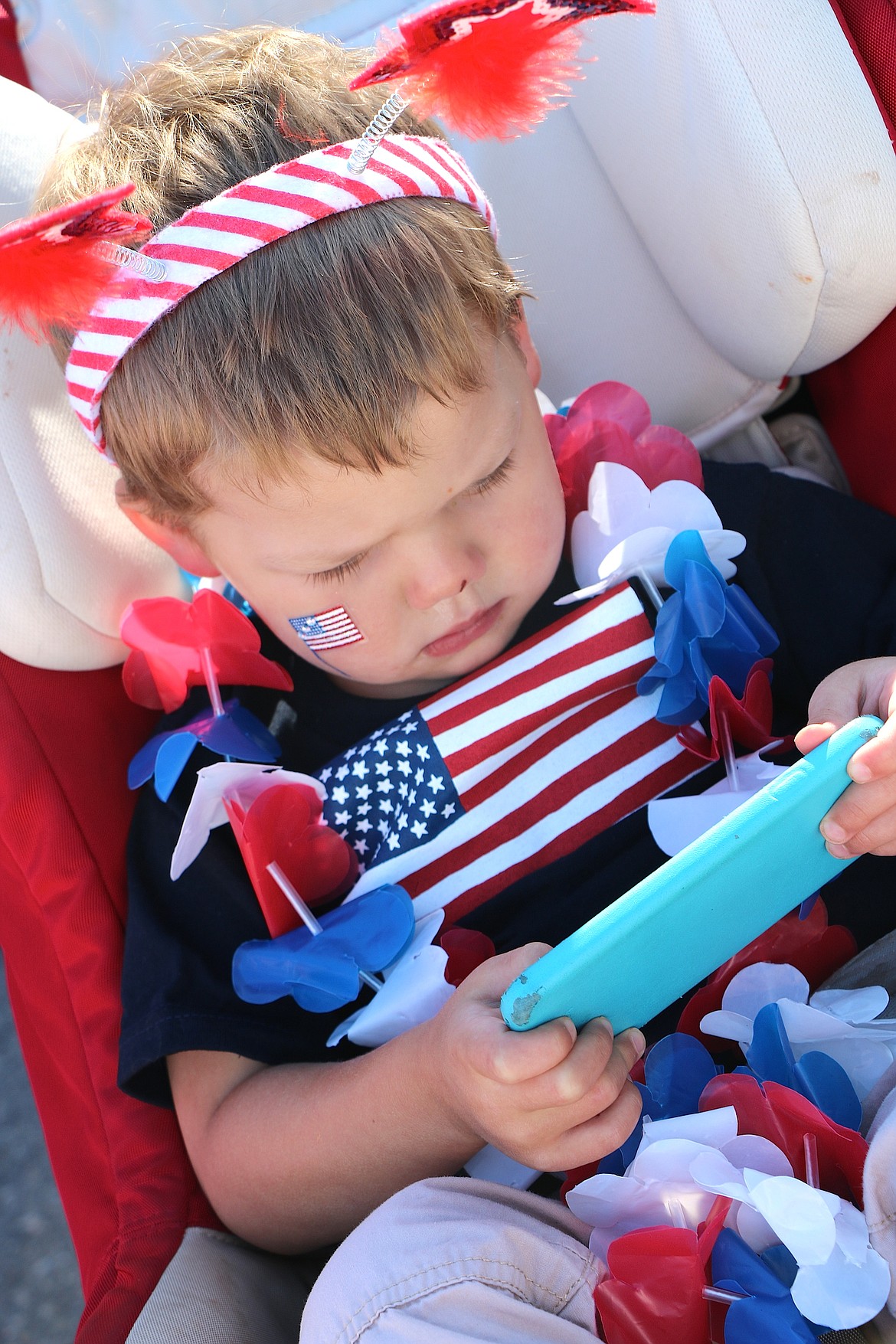 &#151;Photo by CAROLINE LOBSINGER
Grayson Steve Anderson concentrates on a game on his mom&#146;s phone as he waits for the start of the Sandpoint Lions&#146; Kids Parade.