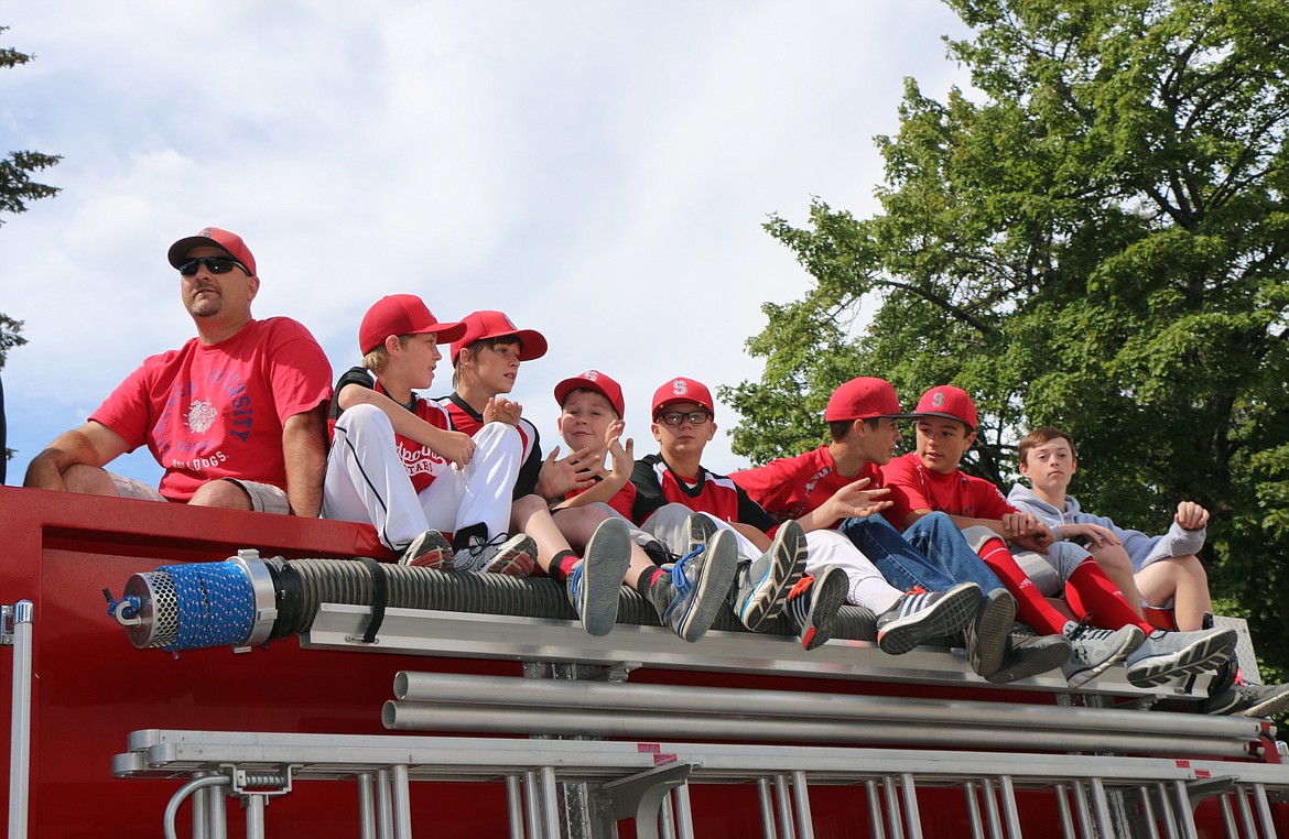 &#151;Photo by CAROLINE LOBSINGER
Members of the Sandpoint All-Stars baseball team take part in the Sandpoint Lions&#146; Grande Parade from atop one of the Selkirk Fire Rescue and EMS firetrucks.