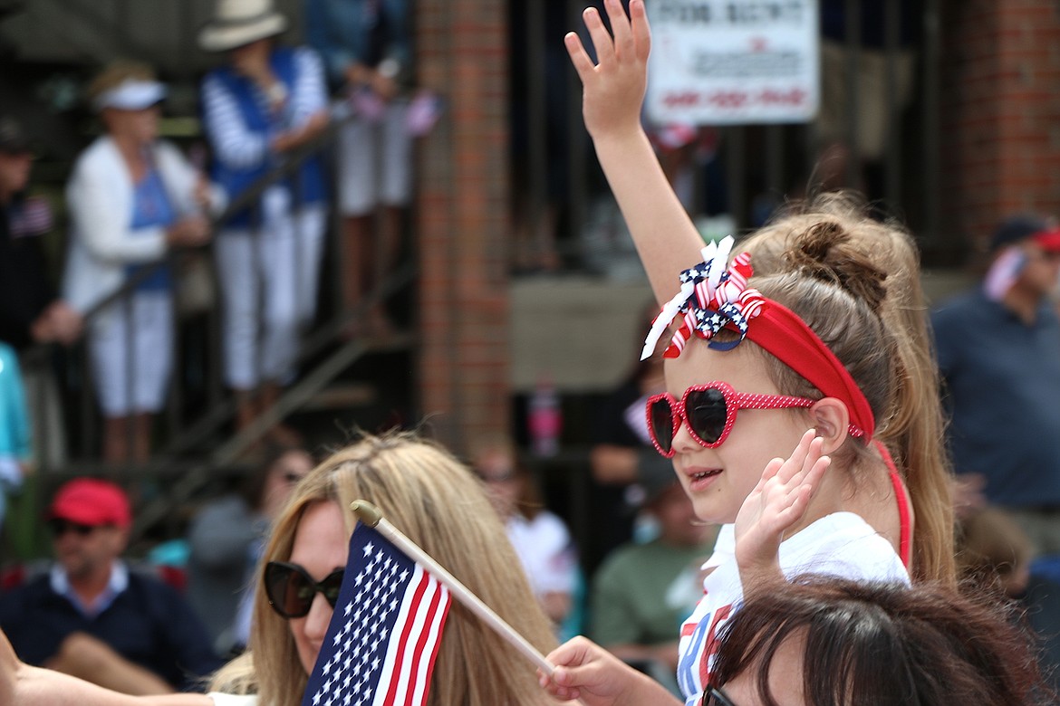 &#151;Photo by CAROLINE LOBSINGER
A young parade participant waves to the crowd while taking part in the Grand Parade on the Fourth of July on Monday.