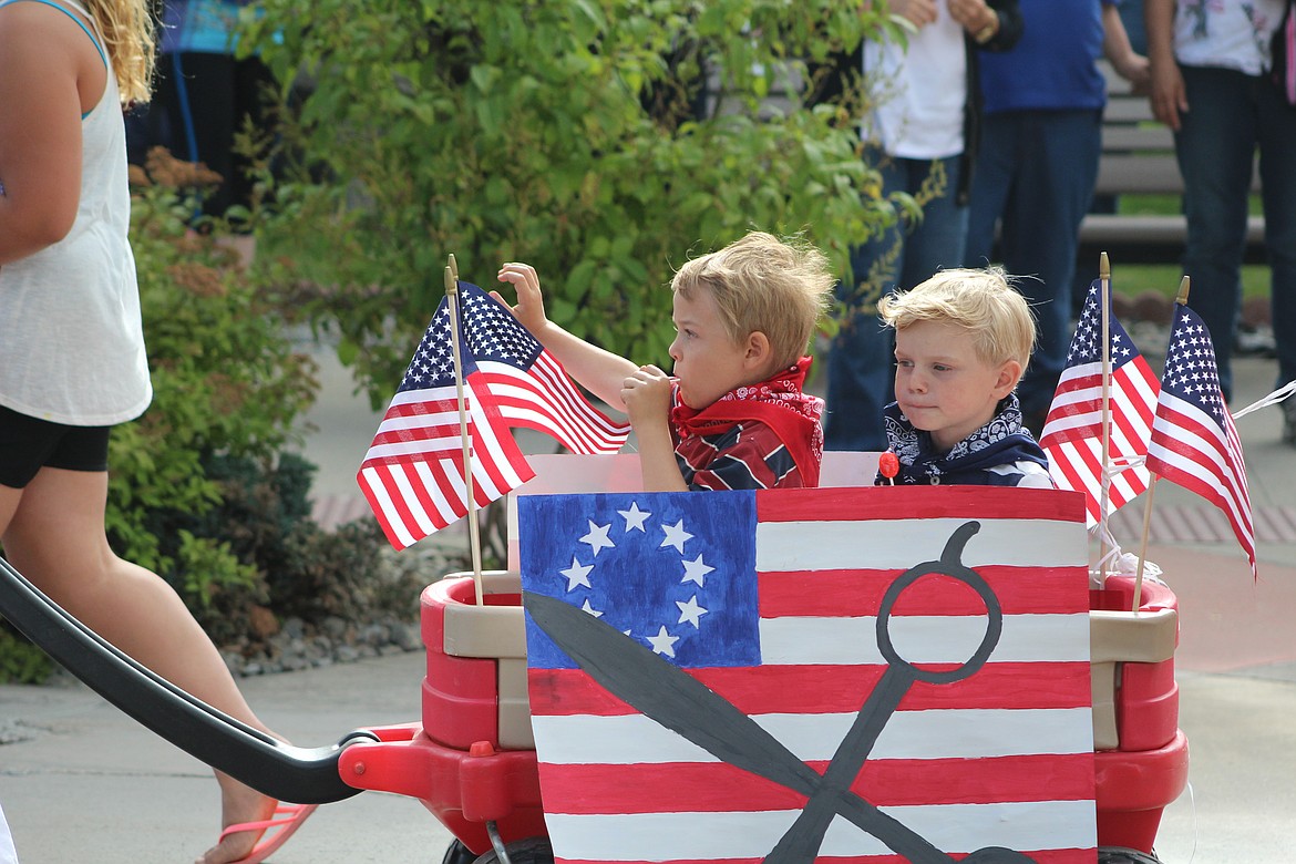 Photo by DON COGGER
A pair of patriotic youngsters enjoy a trip down Main St. Monday during the 2016 4th of July Parade.