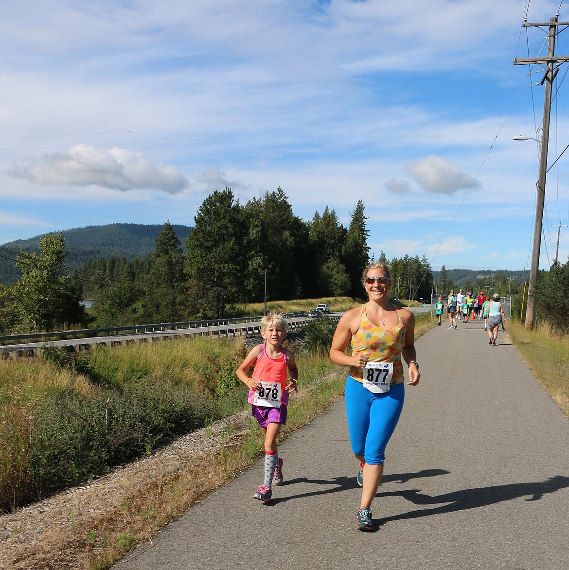 &#151;Photo by CAROLINE LOBSINGER
Beverly and Ammi Midstokke run in Jacey's Race on Sunday.