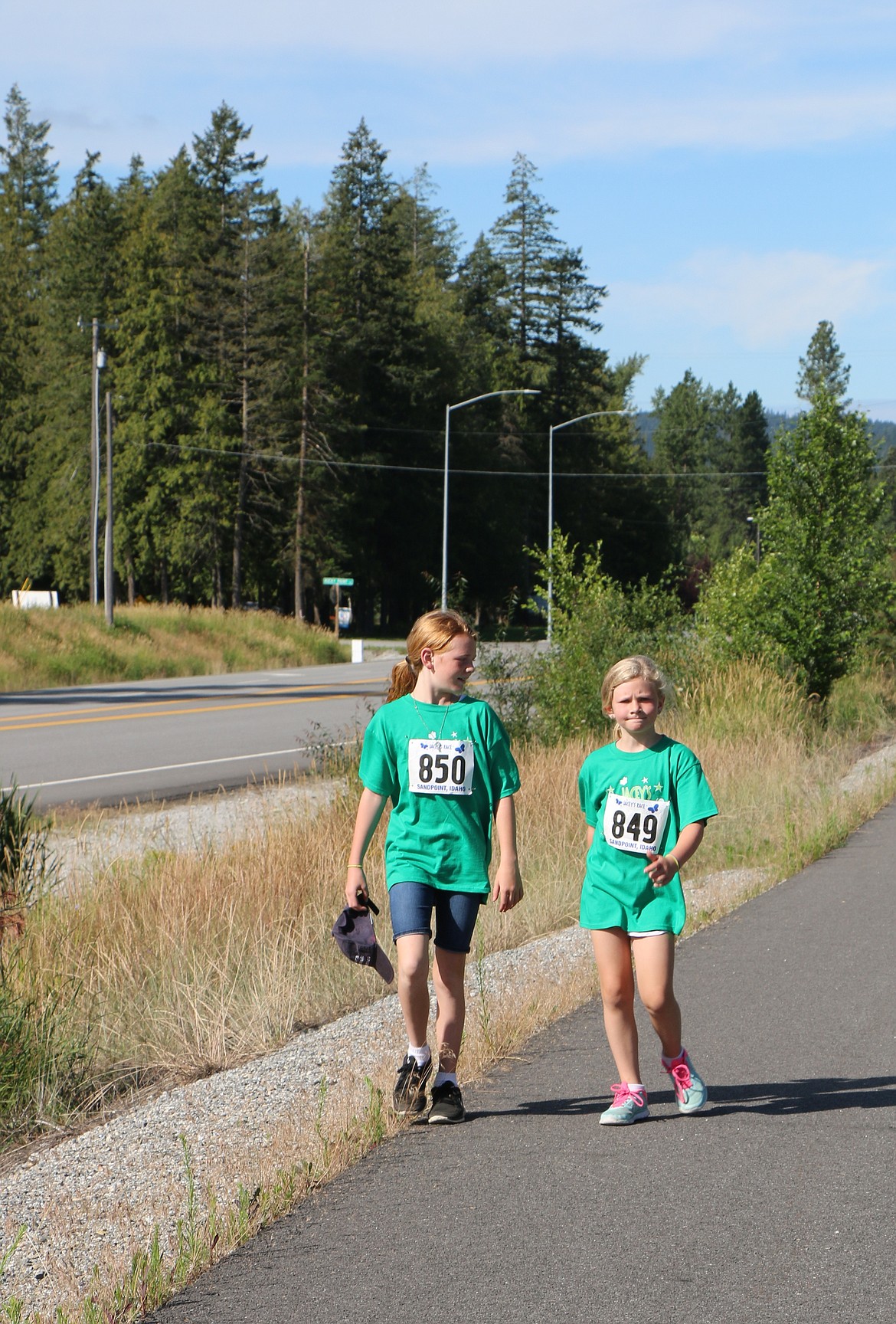 &#151;Photo by CAROLINE LOBSINGER
Betti and Clara Travers walk along the bike path as they take part in the 5K part of Jacey's Race on Sunday.