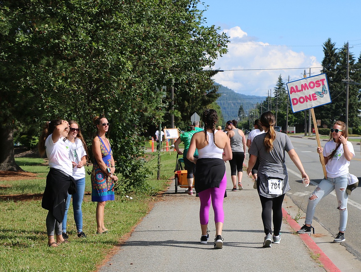 &#151;Photo by CAROLINE LOBSINGER
Local teens cheer on Jacey's Race participants as they near the end of the annual fun run on Sunday.