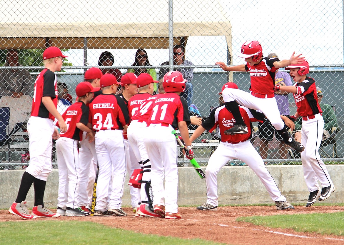 &#151;Photo by ANNA BUTLER
Showing the raw and spontaneous joy that Little League can offer, Avery Bocksch leaps toward home plate and awaiting teammates after swatting a two-run homer in Sandpoint&#146;s 10-9 win over Lewiston on Saturday.