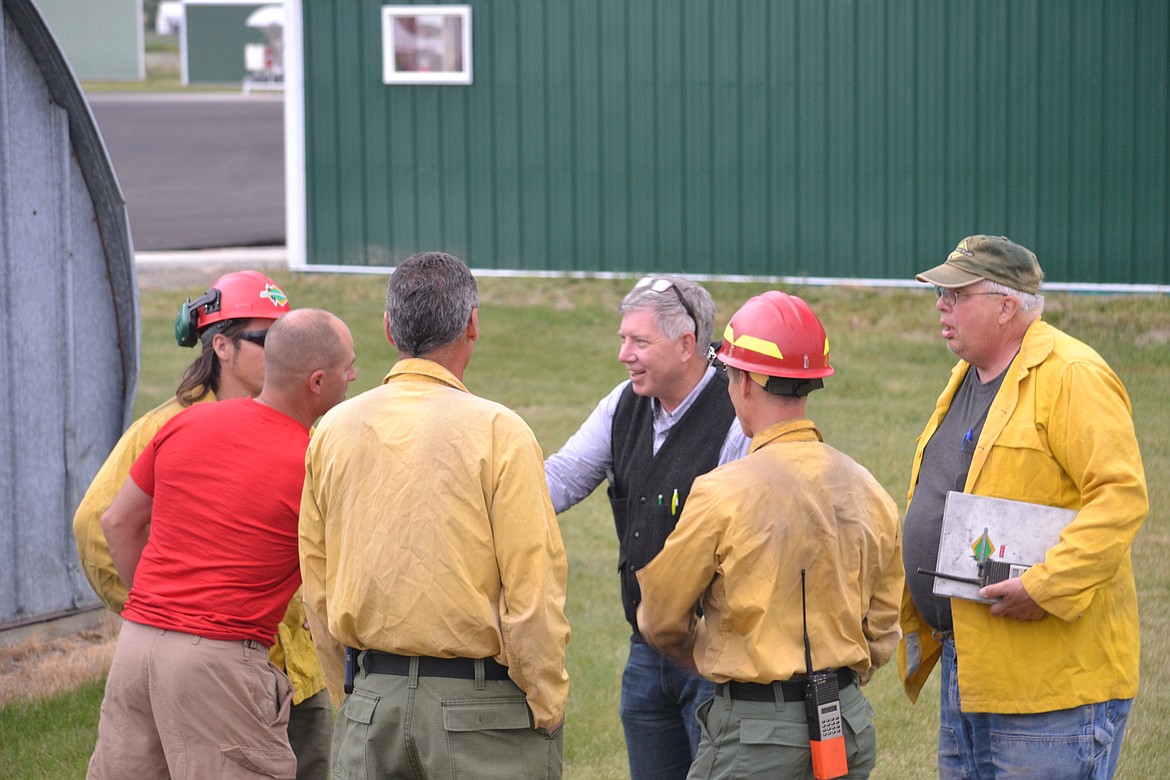 Photo by SARAH JENKINS
Pilot Richard Spaulding greeting Jim Kibler, Idaho Department of Lands.