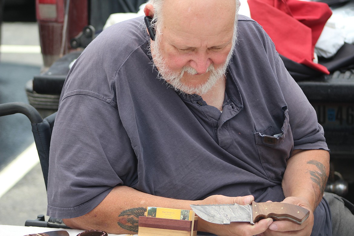 Photo by DON COGGER
Roger Kramer displays a survival knife he designed. The knife has a serrated edge, and can be used for sawing, chopping and and other outdoor tasks.