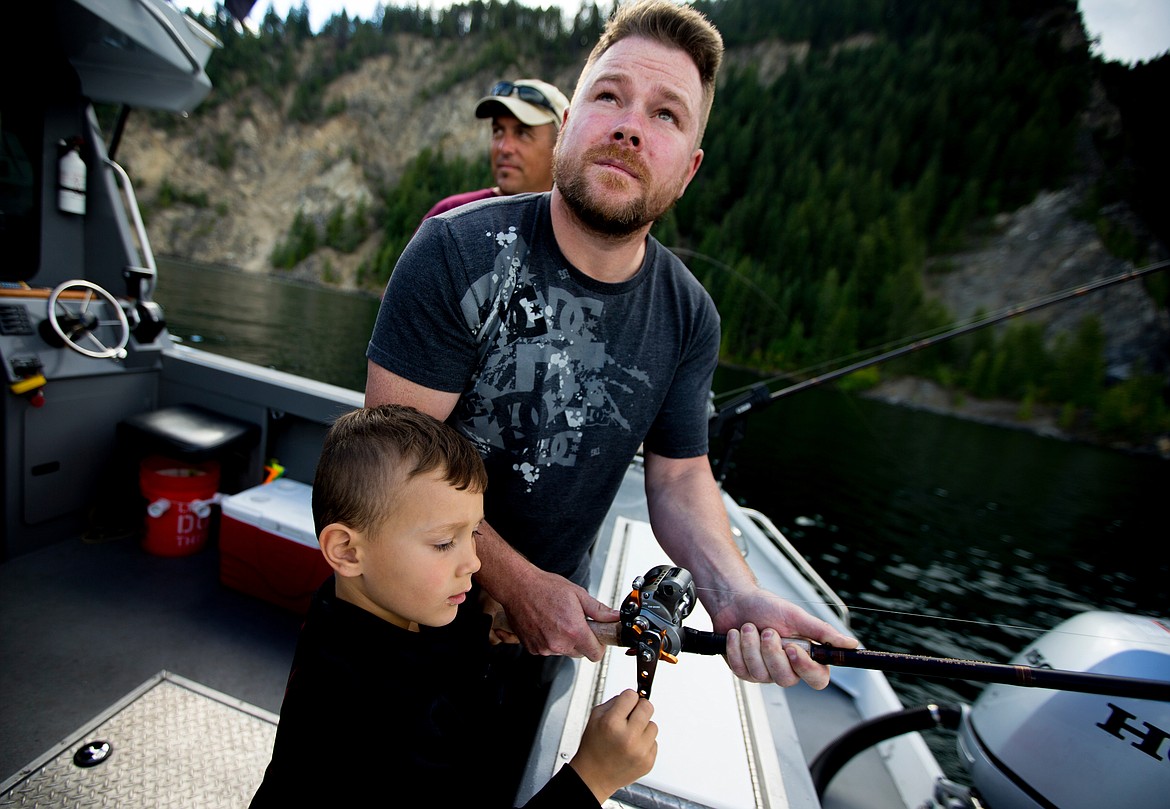 JAKE PARRISH/Press

Army veteran and Purple Heart recipient Jason Rzepa and his 5-year-old son Collin reel in a kokanee salmon on Friday during a fishing trip put on by Boats for Heroes on Lake Pend Orielle. Boats for Heroes, founded by Vietnam veteran Keith Mathews and his wife Cathy, takes veterans and their familes out on free fishing trips in Washington and Idaho.