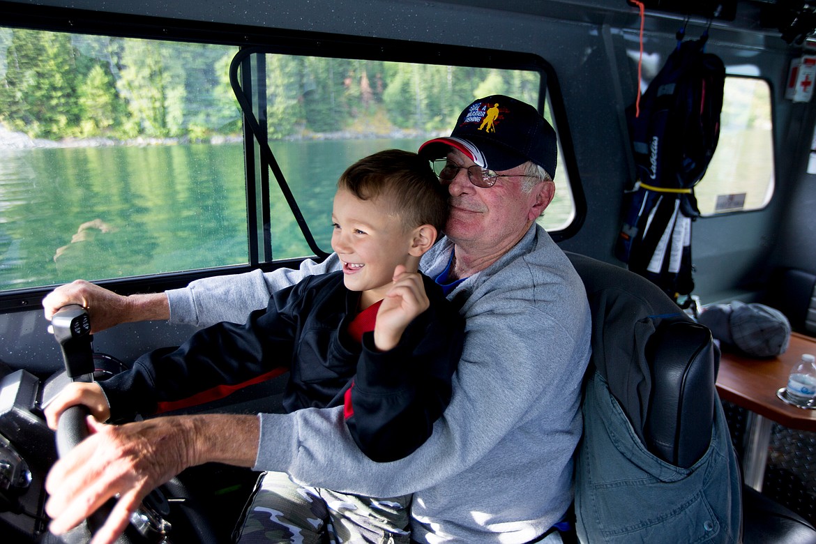 JAKE PARRISH/Press

Boats for Heroes co-founder and Vietnam veteran Keith Mathews lets Collin Rzepa, 5, take control of the 31-foot aluminum fishing boat the nonprofit uses to take veterans on fishing trips in Washington and Idaho.