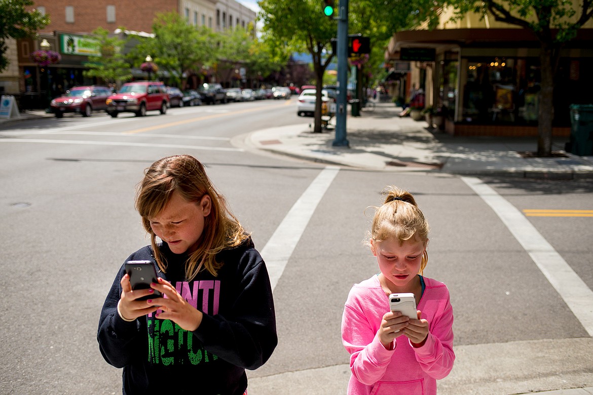 JAKE PARRISH/Press

Jillian Smith, at left, 10, and Dallas Dolence, 7, play Pokemon Go on Monday on the corner of Fifth Street and Sherman Avenue in Coeur d&#146;Alene.