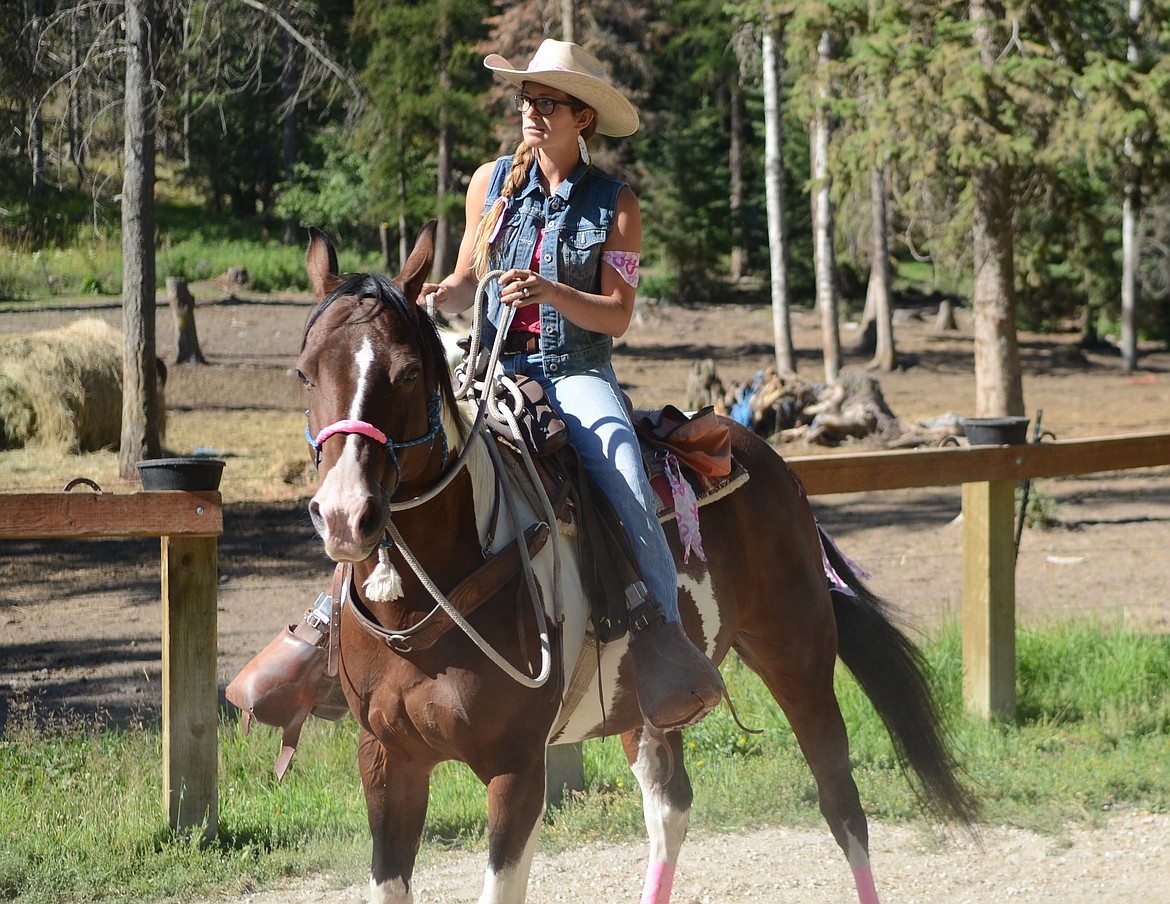 Daniel McKay photos / Whitefish Pilot
Alexis Clevenger leads visitors on guided horse rides at Artemis Acres near Kalispell. The guest ranch is hosting a Pink Week fundraiser this week.