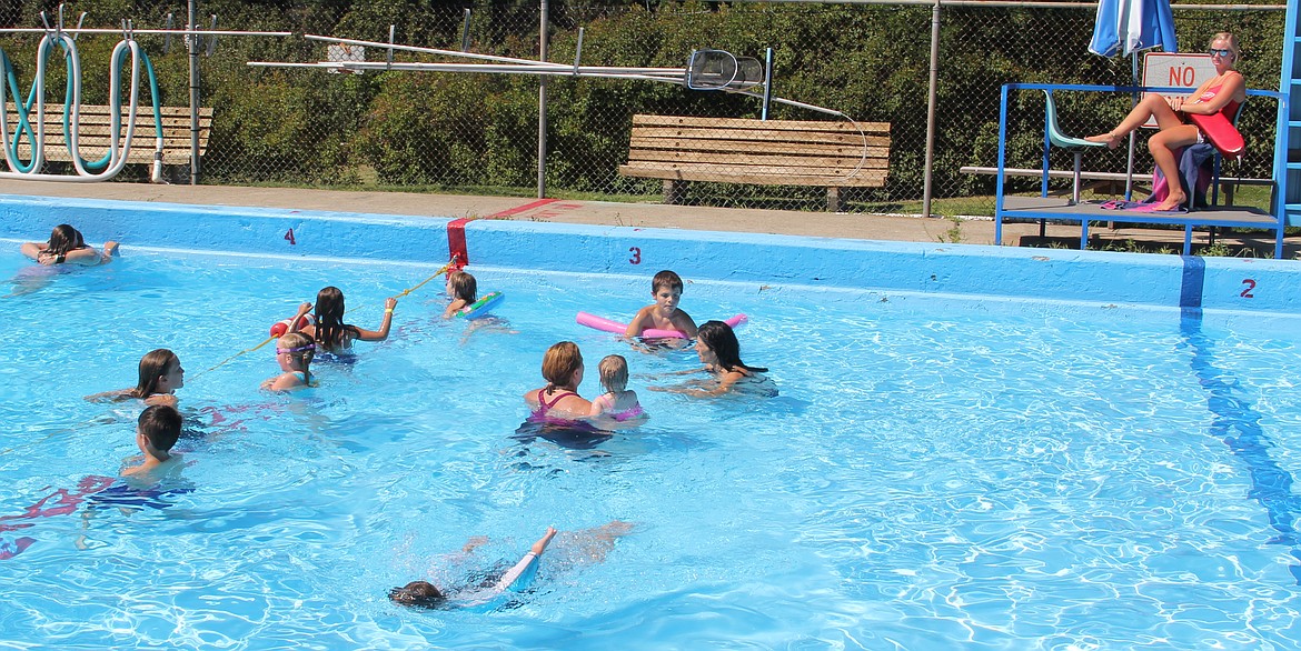 -- Photo by LYNNE HALEY
Mothers and children take advantage of a hot day to chill in the city pool as the lifeguard keeps watch.