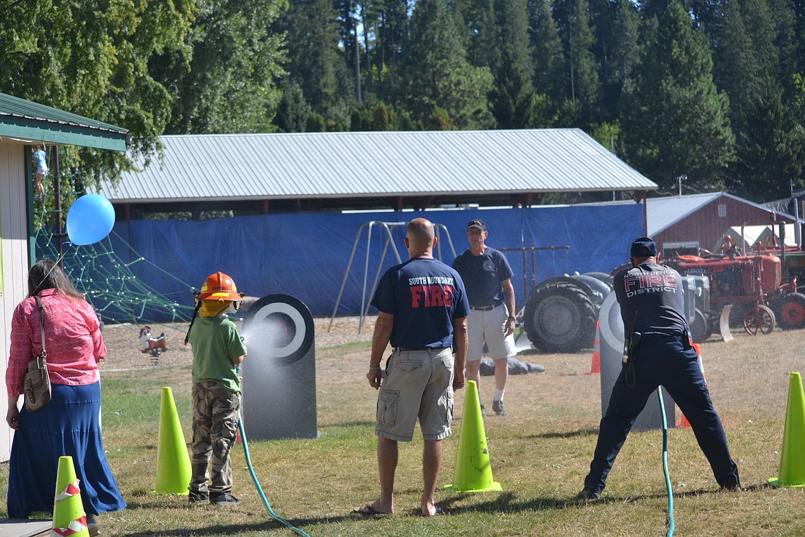 Photo by SARAH JENKINS

South Boundary Fire racing to fill the water bucket against a young fire boy.