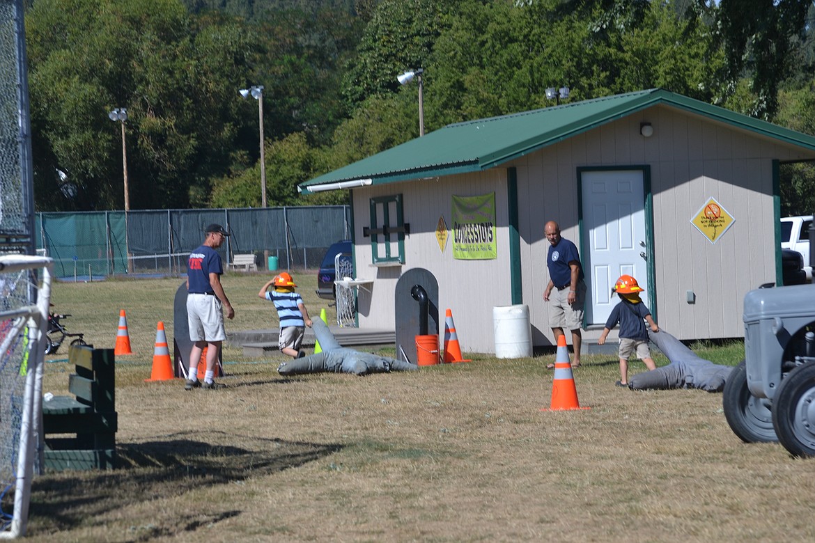 Photo by SARAH JENKINS

South Boundary Fire assisting young fire men at the fair.