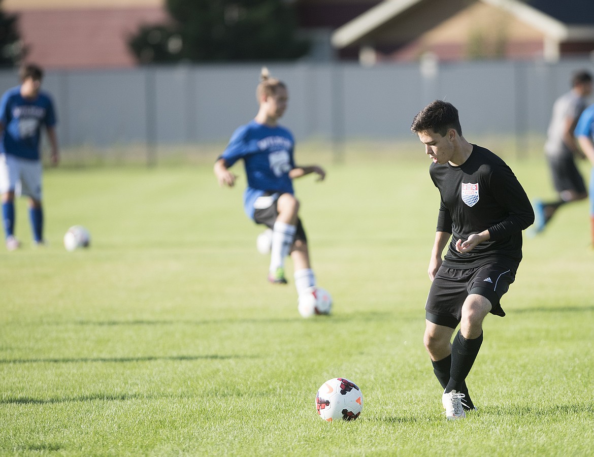 Logan Stephens runs through drills on the first day of soccer practice Mnday.