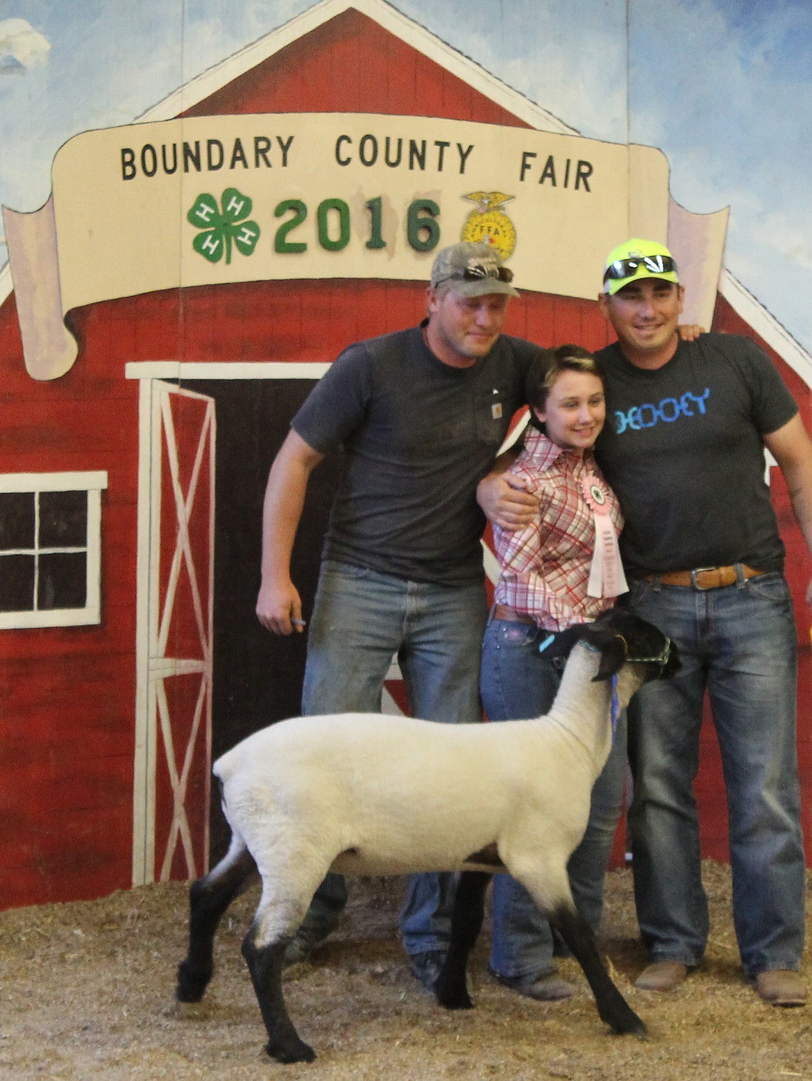 -- Photo by STACIE SHORT

Cassadi Sams, center, and buyers from Joe&#146;s Philly Cheese Steak  with her lamb at the Boundary County Fair stock sale Friday evening.