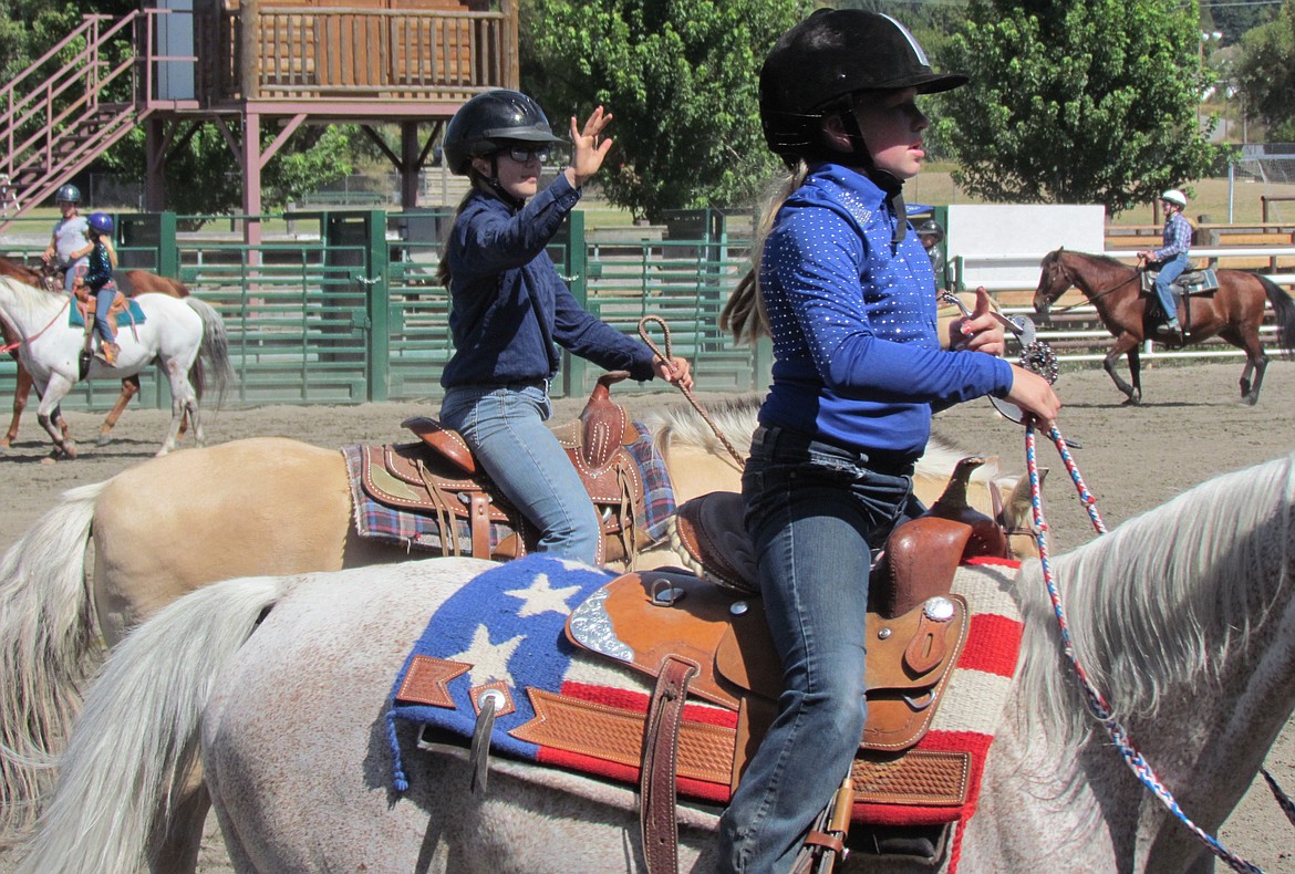 -- Photo by LYNNE HALEY

Horses and riders warm up in the outdoor arena in preparation for the O-Mok-See events.