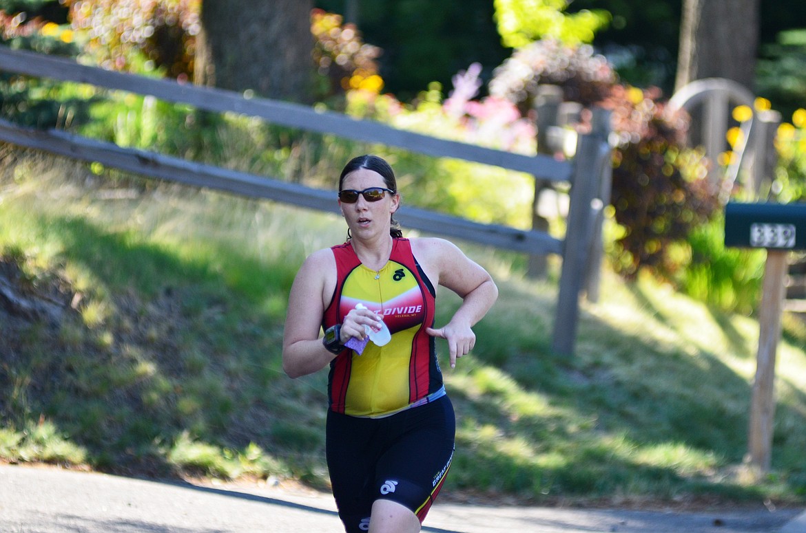 A competitor makes her way down Dakota Avenue Sunday during the run portion of the Whitefish Lake Triathlon. Heidi Desch / Whitefish Pilot